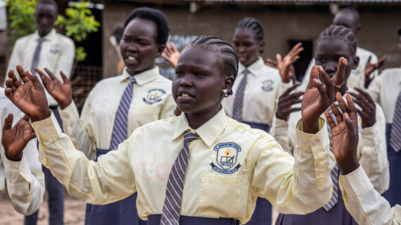 Poetry and drama club students read poems about the ending of GBV and child marriage at Saint Andreas High School.