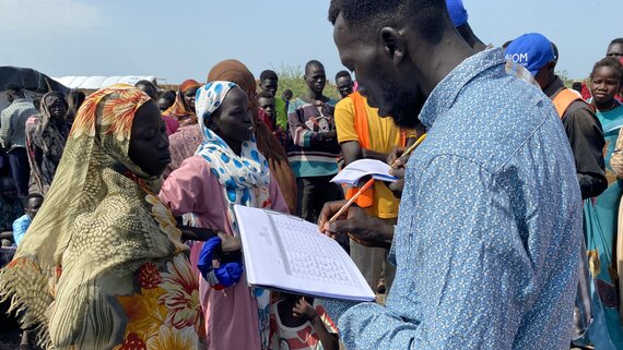 A humanitarian worker recording details of South Sudanese returnees at Joda point of entry in Renk County in Upper Nile State.