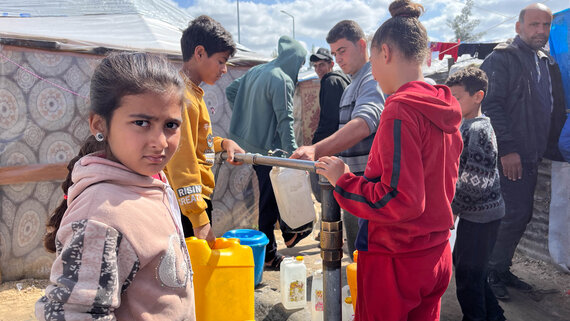 Displaced persons collect water. In Gaza, partners estimate that 67 per cent of water and sanitation facilities have been destroyed or damaged, leaving people to collect water from unreliable resources, which are contributing to elevated levels of disease.