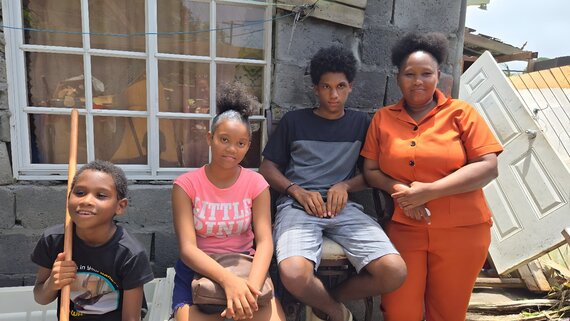 Kingstown, Saint Vincent and the Grenadines: Andrew, 9 (left) recounts how scared he and his family were after the roof came off their home during Beryl. The family is now in one of several shelters