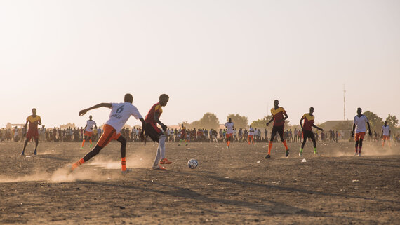 Youth play football at the buffer zone in Bentiu IDP camp sector 5, southern gate.