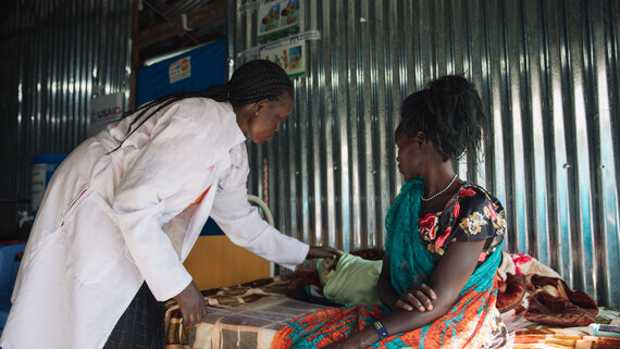 A midwife checks on the progress of a new born in labour ward at the IMC clinic 1 in the Malakal POC site.